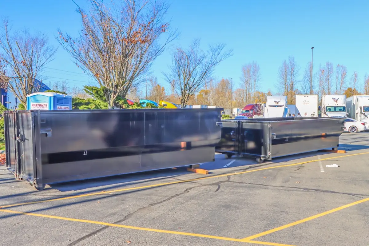 Professional dumpster rental service with roll-off container on residential driveway in Santa Cruz